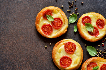 Mini pie with tomatoes and cheese. Quiche with vegetables and sauce top view.