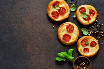 Mini pie with tomatoes and cheese. Quiche with vegetables and sauce top view.