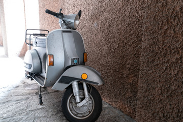 An Italian scooter parked in the village alley