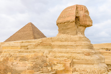 Fototapeta na wymiar The great pyramid of Cheops and Sphinx in Giza plateau. Cairo, Egypt
