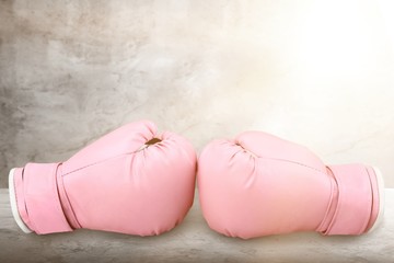 Pink boxing gloves on background