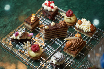 Dessert plate with assortment of sweets, piece of cake, cookies, biscuits