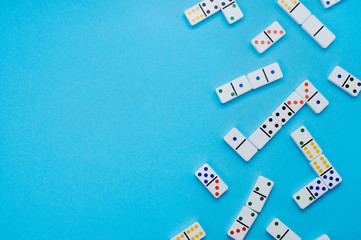 Dominoes on blue background with copyspace