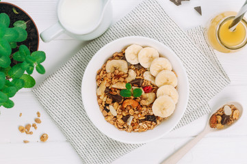 Granola with banana and berries in the bowl