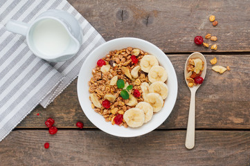 Granola with banana and berGranola with banana and berries in the bowl