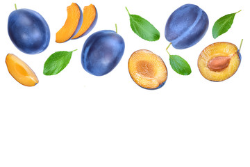 fresh plum and half with leaves isolated on white background. Top view. Flat lay