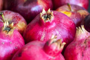 Raw and ripe purple pomegranate fruits close up image, a concept for a Rosh Hashanah Jewish New Year image. 