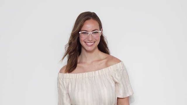Portrait of a Model with Eyeglasses Posing for the Camera on White Background