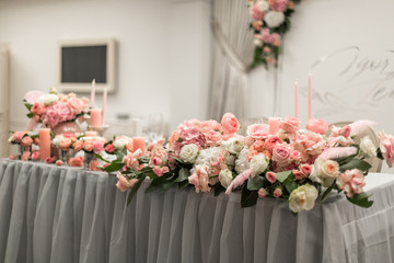 Decor for the holiday table. Natural flowers candle holders in pink colors.