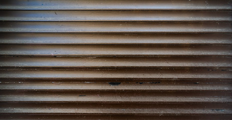 Dark worn out texture of closed metal shutters