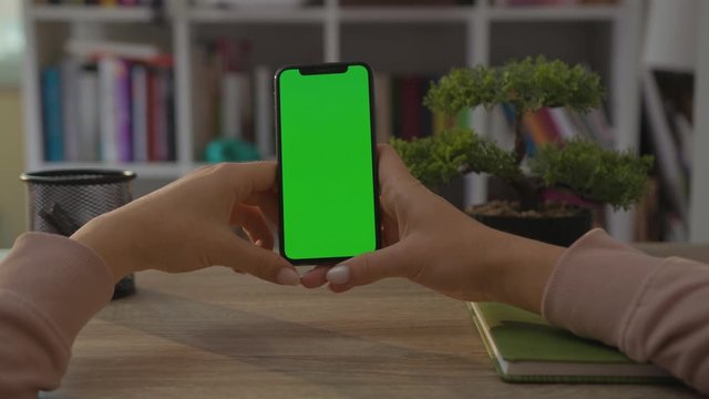 Girl Using Phone Vertical Green Screen Living Room Arri Alexa Mini Hands Holding Smartphone. GREEN SCREEN. Fingers Modern Display. Smart Phone. Tapping. Scrolling. Messaging.