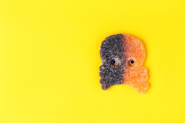 Sweet marmalade skull and crossbones. Minimal composition for the fall Halloween holiday.