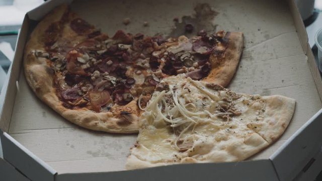 Background of box with pizza biten off portions. 4K