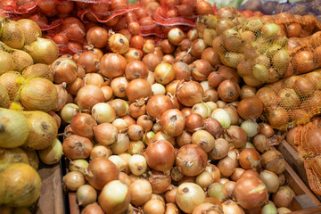 Onions at the a supermarket counter. Background.