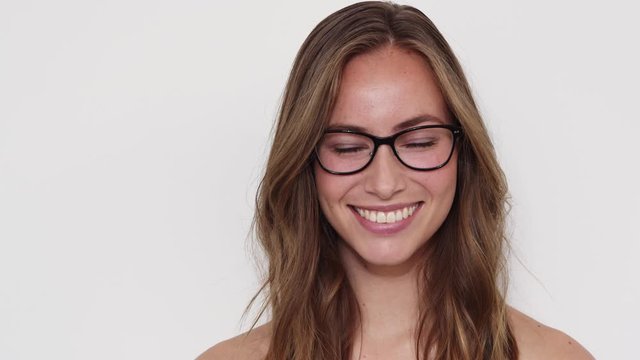 Woman with Beautiful Smile Swaying Her Body while Fixing Her Black Eyeglasses