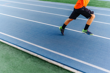 Boy running on running track