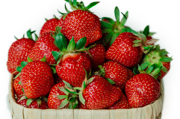 ripe and tasty strawberries in a wicker bowl