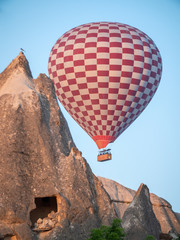 Fototapeta na wymiar red and white hot air balloon flying over cappadocia