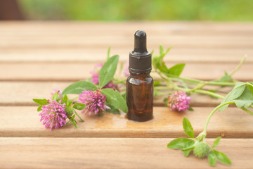 Essence of flowers on table in beautiful glass jar