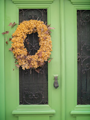 green door with glass windows and a flower wreath