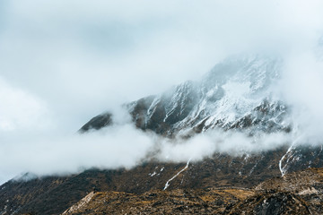 Beautiful Himalaya mountains covered with snow and wrapped in fog, Manaslu Circuit Trek.