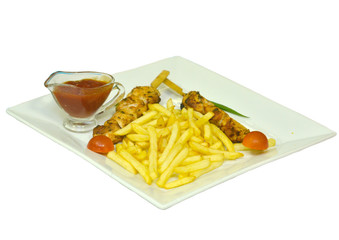 Delicious chicken kebab with French fries and sauce on a plate