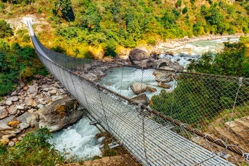 Papier Peint photo Manaslu Metal cable bridge in Nepal, Himalayas, Manaslu circuit trek.