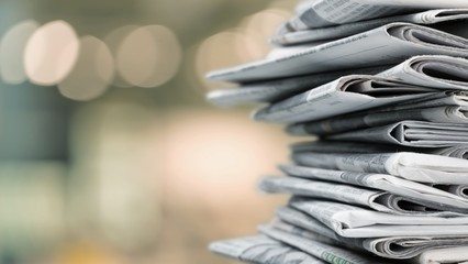 Pile of newspapers on white background