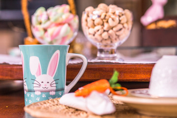 Fototapeta na wymiar Easter sweets with blue bunny cup