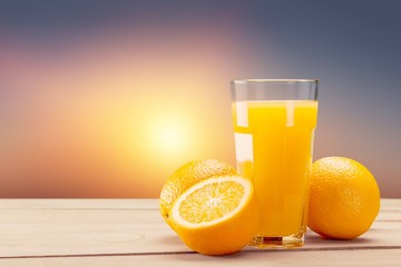Orange juice and slices of orange on background