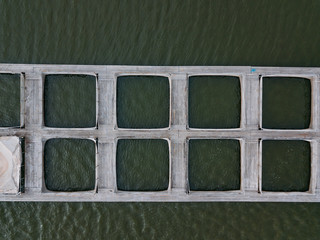 Fish cages in farm for breeding fish, drone top view