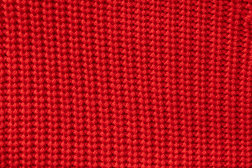 Red knitted winter sweater Background, red texture