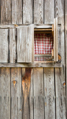 Obraz na płótnie Canvas weathered wood farmhouse with open window