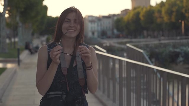 A beautiful woman tourist walks through the historical center of the French city of Narbonne. River canal in the city center
