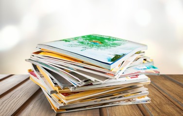 Stack of magazines on white background