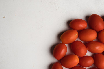 grape tomatoes scattered on white background