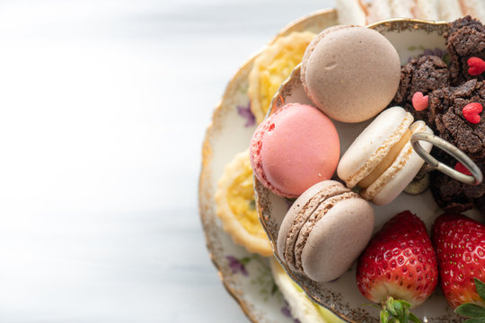 High Tea Tray from Above with Macaroons, Strawberries, Brownies with Copy Space