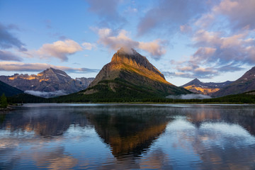 Naklejka na ściany i meble Sunrise of the Mount Wilbur, Swiftcurrent Lake in the Many Glacier area of the famous Glacier National Park