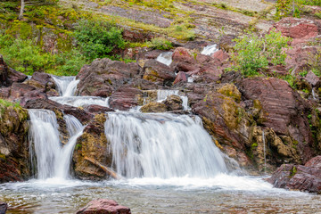 The beautiful waterfall in the Redrock Lake area of the famous Glacier National Park