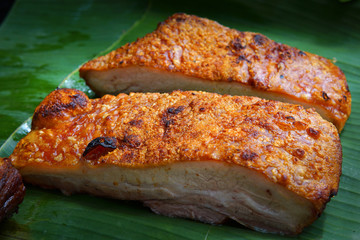 Crispy pork placed on a banana leaf