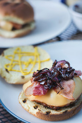Delicious late summer grilled hamburgers with bacon sauteed onion and melted gouda cheese.