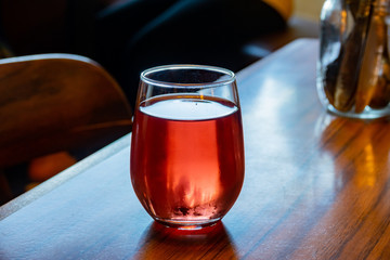 Close up shot of a cup of cold sweet red wine