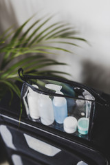 packing for a flight, transparent bag with small lotions for liquids and gel for security check compliance inside cabin luggage