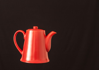 red coffee pot on black rustic background