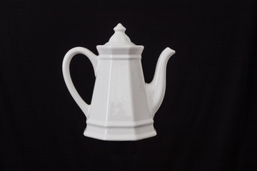 white coffee pot on black rustic background