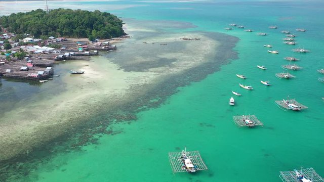 Aerial view of drone fliying over fishing boat at Tanjung Binga fishing Village in Belitung Island Indonesia. Fishing Boat on Clear water.