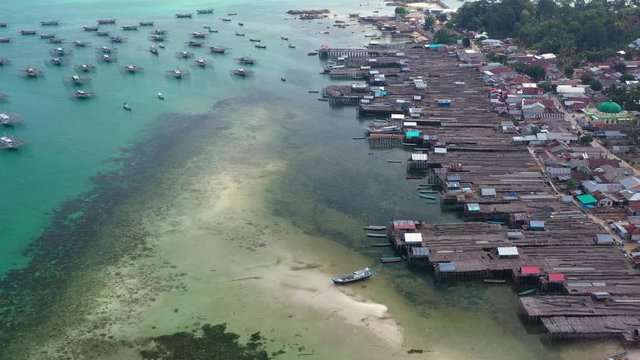 Aerial view of drone fliying over fishing boat at Tanjung Binga fishing Village in Belitung Island Indonesia. Fishing Boat on Clear water.