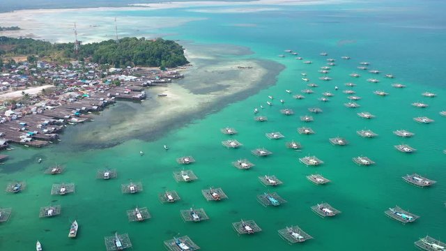 Aerial view of drone fliying over fishing boat at Tanjung Binga fishing Village in Belitung Island Indonesia. Fishing Boat on Clear water.