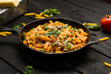 Italian pasta skillet dish. This quick & delicious pasta meal is made with penne pasta, fresh tomato sauce and sausage. This italian inspired comfort food is cooked and served in a cast iron skillet.