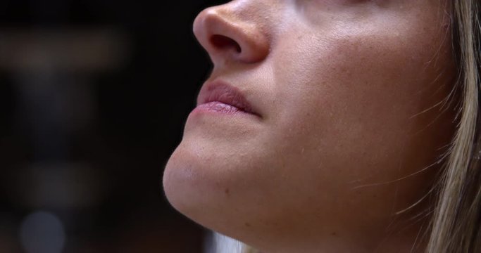 Young woman traveling explores museum - reading about art before looking up - extreme close up on face